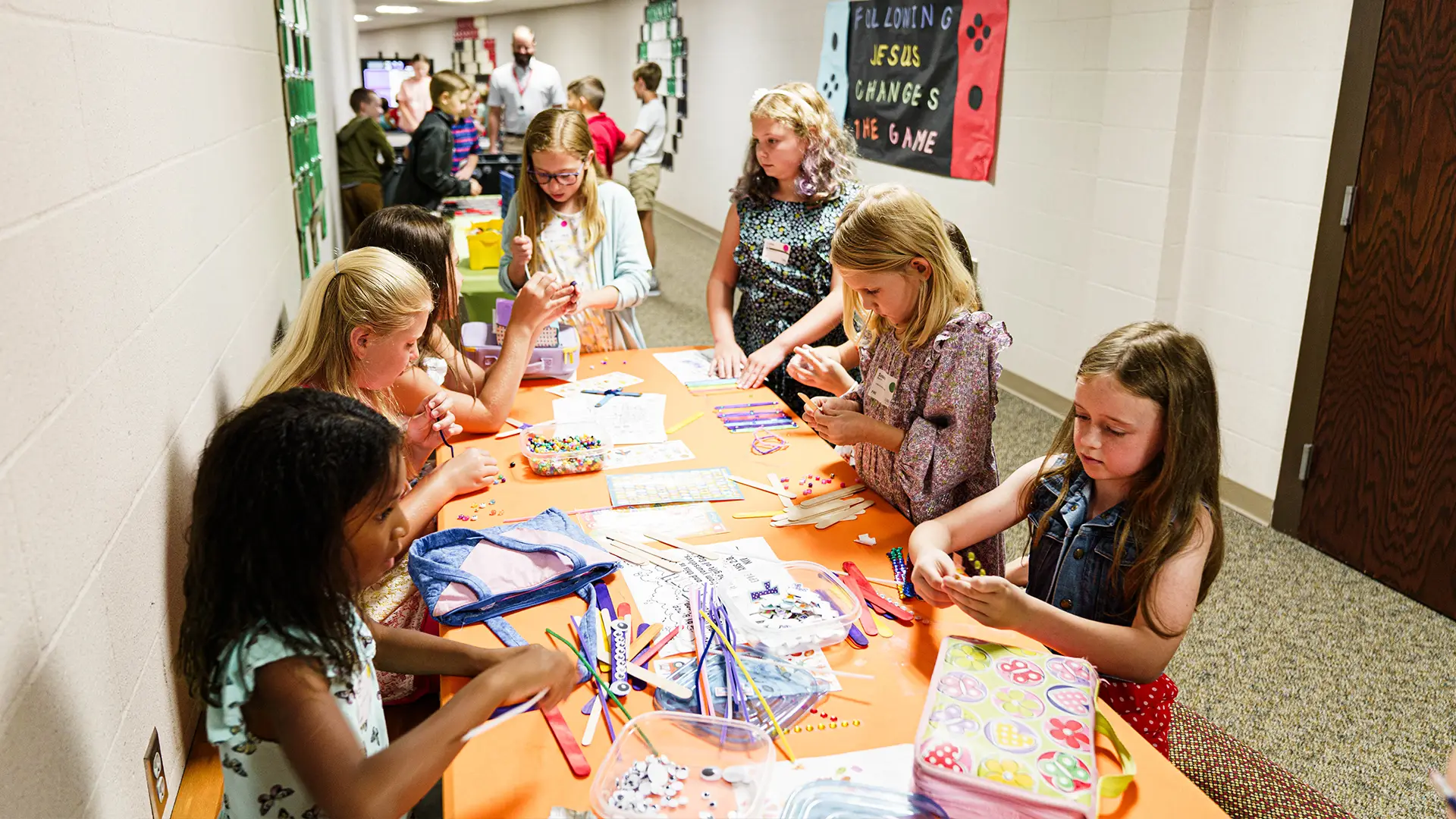 kids in a hallway making crafts