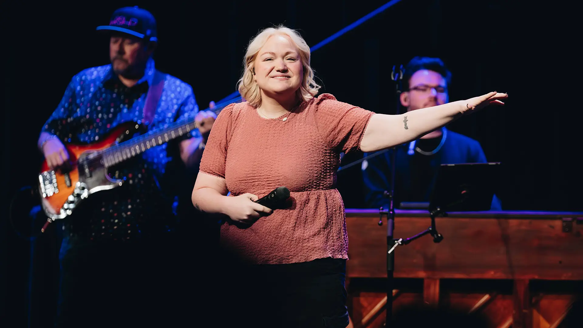 lady on stage leading worship