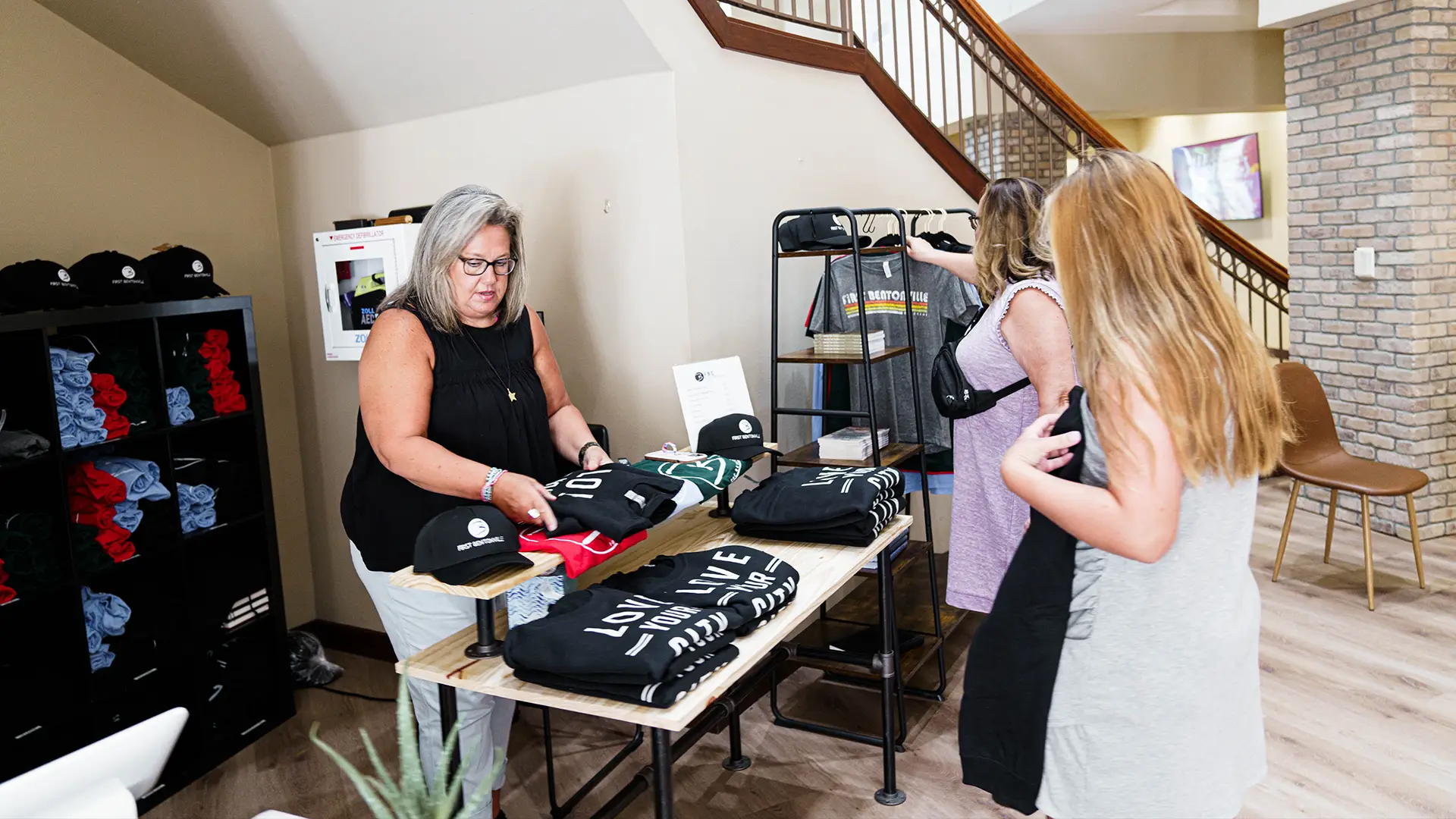 woman selling merchandise to two ladies